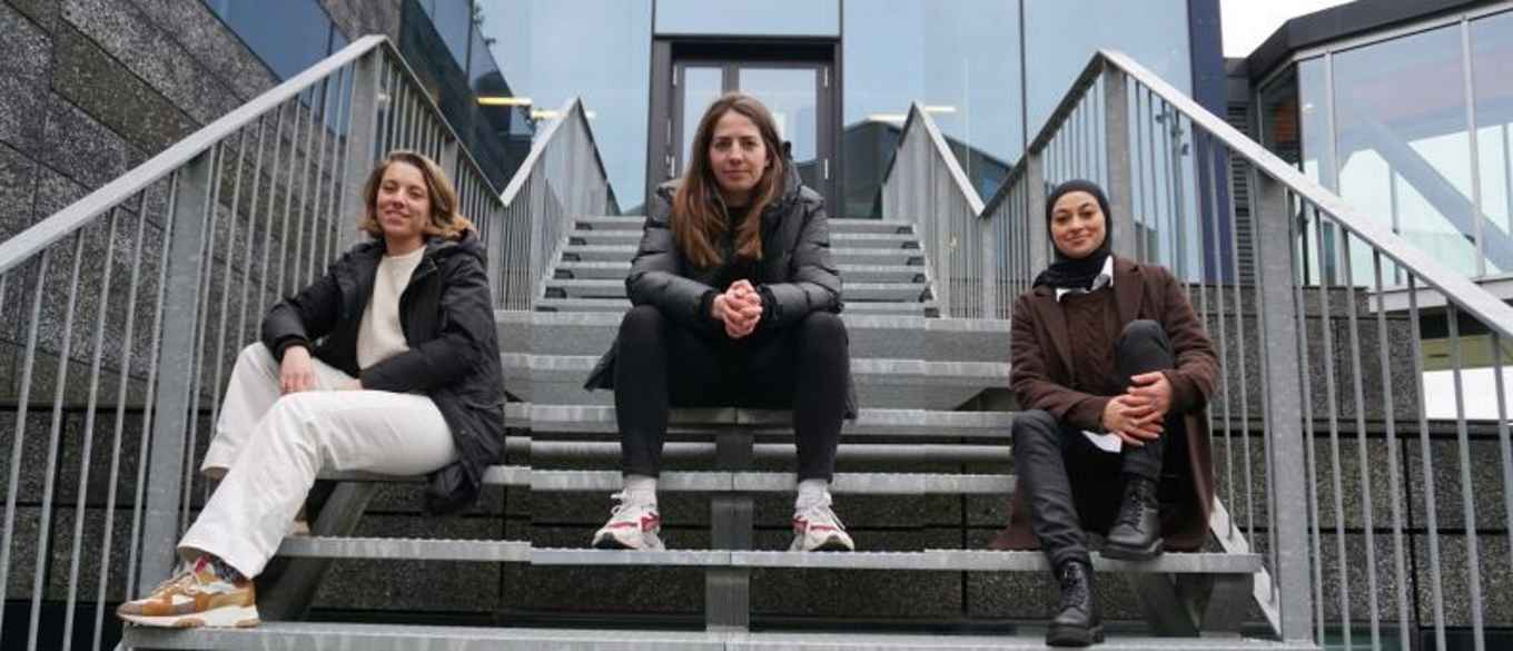 The three sisters in science sitting on stairs